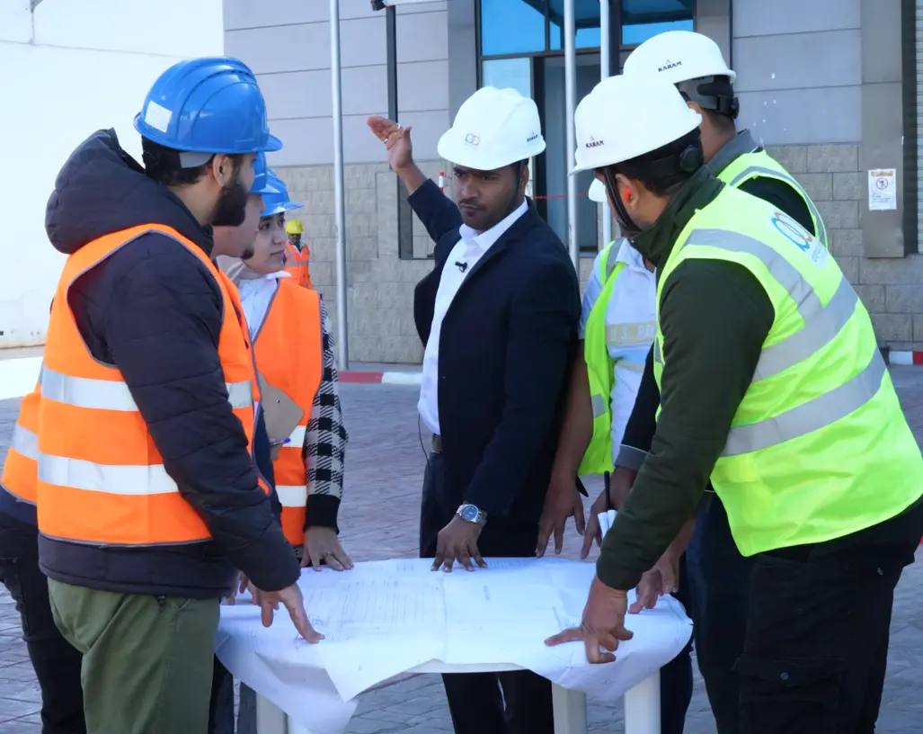 Project manager reviewing plans on site